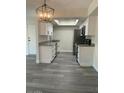 Modern kitchen with white cabinets, gray flooring, and stainless steel appliances at 6480 N 82Nd St # 2203, Scottsdale, AZ 85250