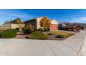 House with red garage door and manicured landscaping at 17966 W Highland Ave, Goodyear, AZ 85395