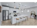 Modern kitchen with white cabinets, island with seating, and stainless steel appliances at 20865 E Timberline Rd, Queen Creek, AZ 85142