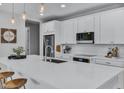 Modern kitchen with white cabinets, quartz countertops, and stainless steel appliances at 20865 E Timberline Rd, Queen Creek, AZ 85142
