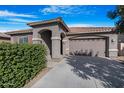 One-story house with a two-car garage and neatly trimmed bushes at 21576 E Pecan Ct, Queen Creek, AZ 85142