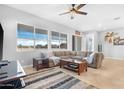 Bright living room with comfy sectional sofa, coffee table, and large windows at 21576 E Pecan Ct, Queen Creek, AZ 85142