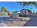 Landscaped front yard with gravel, desert plants, and a two-car garage at 3214 N Desert Horizons Ln, Casa Grande, AZ 85122
