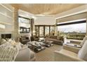 Spacious living room with fireplace and expansive windows at 5630 E Rockridge Rd, Phoenix, AZ 85018
