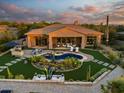 Luxury home with a circular pool and extensive backyard landscaping at 6450 E Bent Tree Dr, Scottsdale, AZ 85266