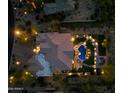 Night view of a luxurious home with a large pool and landscape lighting at 6450 E Bent Tree Dr, Scottsdale, AZ 85266