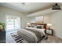 Virtually staged main bedroom with sliding door to patio at 11806 N 40Th Pl, Phoenix, AZ 85028