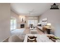 Virtually staged living room with fireplace and patio access at 11806 N 40Th Pl, Phoenix, AZ 85028