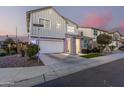 Two-story house with gray siding, stone accents, and a two-car garage at 1372 W Crane Dr, Chandler, AZ 85286