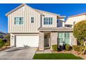 Two-story home with gray siding, stone accents, and a two-car garage at 1372 W Crane Dr, Chandler, AZ 85286