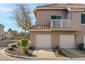 Two-story building with attached garages, landscaping and a walkway at 1633 E Lakeside Dr # 113, Gilbert, AZ 85234