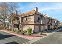 Two-story building with Spanish-style tile roofing, balconies, and landscaping at 1633 E Lakeside Dr # 113, Gilbert, AZ 85234