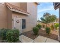 Front door entrance to a condo unit with landscaping at 1633 E Lakeside Dr # 113, Gilbert, AZ 85234