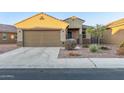 Front view of a one-story house with a two-car garage at 21612 W Kimberly Dr, Buckeye, AZ 85326