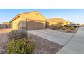 House exterior showcasing a two-car garage and driveway at 21612 W Kimberly Dr, Buckeye, AZ 85326