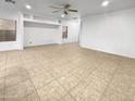 Spacious living room featuring tile floors and a ceiling fan at 521 E Cheyenne Rd, San Tan Valley, AZ 85143