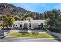 Stunning aerial view of a luxurious estate home nestled against a mountain backdrop at 5301 E Roadrunner Rd, Paradise Valley, AZ 85253