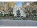 Elegant home with ornate iron front doors and beautifully landscaped entryway at 5301 E Roadrunner Rd, Paradise Valley, AZ 85253