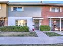 Attractive townhome exterior featuring brick and gray siding, a well-maintained lawn at 8405 E Montebello Ave, Scottsdale, AZ 85250