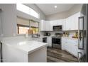 Modern kitchen with white cabinets, stainless steel appliances, and quartz countertops at 4636 E Danbury Rd, Phoenix, AZ 85032