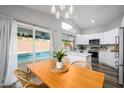 Bright kitchen with an island, dining area, and view of the backyard pool at 4636 E Danbury Rd, Phoenix, AZ 85032