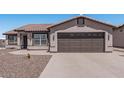 Single-story home with a two-car garage and desert landscaping at 5736 E Lawndale St, Mesa, AZ 85215