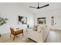 Bright living room with light beige couch and wooden accent chair at 8517 W Campbell Ave, Phoenix, AZ 85037