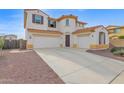 Two-story house with a three-car garage and desert landscaping at 15663 W Sierra St, Surprise, AZ 85379