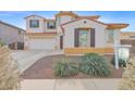 Two-story house with a three-car garage and landscaping at 15663 W Sierra St, Surprise, AZ 85379