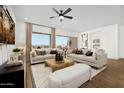 Bright living room featuring two sofas and large windows at 17328 W Via Dona Rd, Surprise, AZ 85387