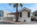 Tan mobile home with carport, small porch, and landscaping at 250 Beryl Dr, Apache Junction, AZ 85119