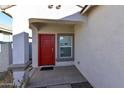 Covered entryway with red front door and single window at 3372 W Stanton Ave, Apache Junction, AZ 85120