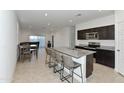 Open kitchen features granite island and dark cabinetry at 3372 W Stanton Ave, Apache Junction, AZ 85120