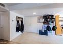 Bright entryway with tile flooring, coat rack, and shoe storage at 3953 W Evans Dr, Phoenix, AZ 85053