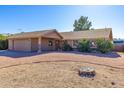 House exterior showcasing a large front yard and attached garage at 3953 W Evans Dr, Phoenix, AZ 85053