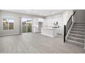 Open living room with kitchen island and modern staircase at 4923 E Village Dr, Scottsdale, AZ 85254