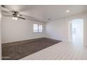 Bright living room with carpet and tile flooring, and ceiling fan at 8575 W Maya Dr, Peoria, AZ 85383