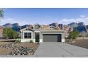 One-story house with gray exterior and mountain views at 18341 W Desert Hollow Dr, Wittmann, AZ 85361