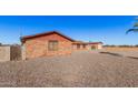 Side view of brick house with a gravel yard at 24906 W Boone Dr, Casa Grande, AZ 85193