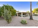 Front view of the house with carport and nicely landscaped yard at 707 S Desert Flower S Dr, Mesa, AZ 85208