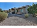 Covered patio with hot tub and grill, overlooking a gravel backyard at 7132 W Trenton Way, Florence, AZ 85132