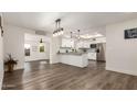 Bright dining area with wood-look floors and views into the kitchen at 8039 E Madero Ave, Mesa, AZ 85209