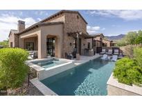 Luxury pool and spa with stone accents and patio furniture at 3089 S Prospector Cir, Gold Canyon, AZ 85118