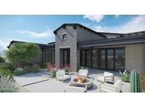 Modern home exterior with stone accents and fire pit at 8614 E Artisan Pass Pass # 125, Scottsdale, AZ 85266