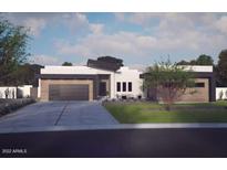Modern home exterior with two-car garage and landscaping at 10535 E Paradise Dr, Scottsdale, AZ 85259