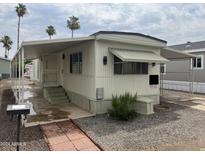 Mobile home with carport and brick walkway at 7300 N 51St Ave # 208, Glendale, AZ 85301