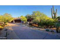 Desert landscape with driveway leading to contemporary home at 41327 N 106Th St, Scottsdale, AZ 85262