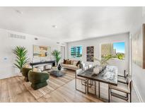 Open living area with hardwood floors, modern furniture, and city views at 3131 N Central Ave # 3018, Phoenix, AZ 85012