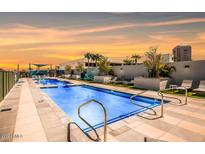 Community pool with plenty of lounge chairs for relaxing at 3131 N Central Ave # 3015, Phoenix, AZ 85012