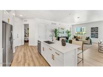 Open concept kitchen with island, stainless steel appliances, and white cabinets at 3131 N Central Ave # 3012, Phoenix, AZ 85012